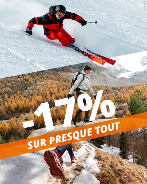 Un skieur carve dans la poudreuse au-dessus d